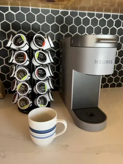 Get your morning off to the perfect start with our Keurig coffee maker, ready to brew a fresh cup of your favorite blend in seconds! Whether you prefer a hot cup of coffee, tea, or cocoa, our Keurig has got you covered.