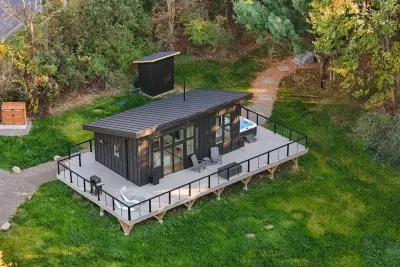 Tucked away on 24 acres of private woods, The Kimberly offers the perfect mix of modern design and peaceful seclusion. 1,000 sq ft. wrap around deck including hot tub, cold plunge, fire pit, grill and loungers. A stone path leads to the Kuro sauna.