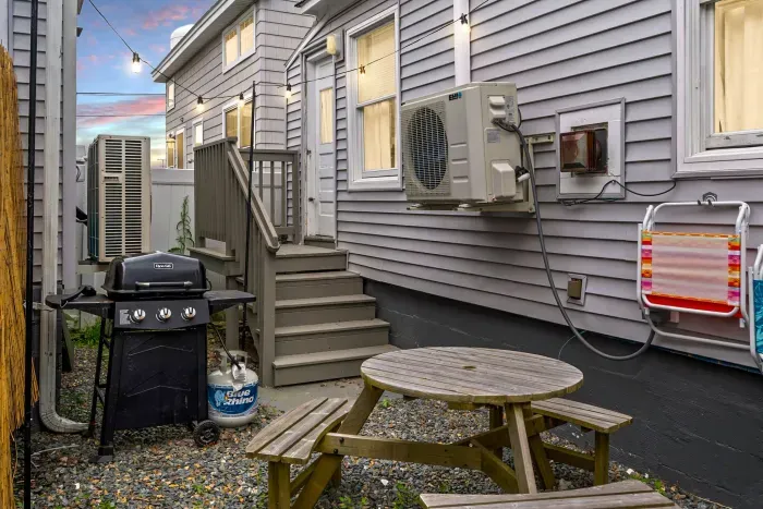 Fully renovated grilling area with new landscaping and furniture.