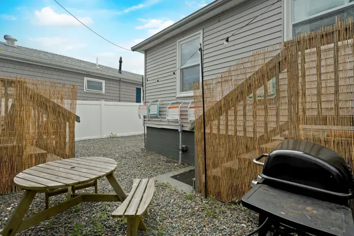 Fully renovated grilling area with new landscaping and furniture.