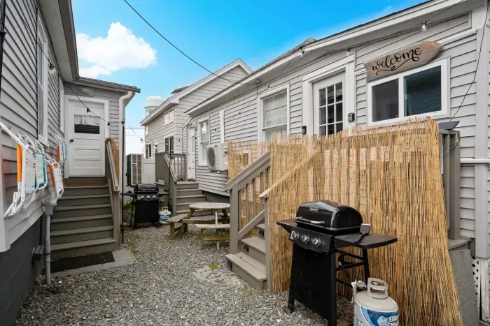 Fully renovated grilling area with new landscaping and furniture.