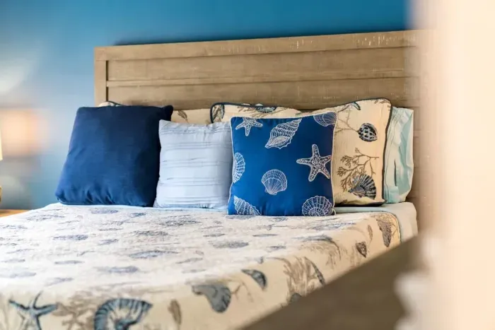 Bedroom with queen bed, en-suite bathroom with double sink, stand up shower and stackable washer/dryer