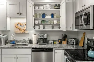 Open living room & kitchen, with mounted smart TV, Dining table, strong WiFi, sleeper sofa and fully-equipped kitchen
