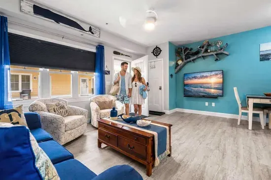 Enjoy the summer in an open living room & kitchen, with mounted smart TV, Dining table, strong WiFi, sleeper sofa and fully-equipped kitchen