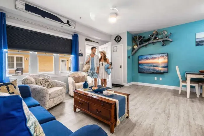 Enjoy the summer in an open living room & kitchen, with mounted smart TV, Dining table, strong WiFi, sleeper sofa and fully-equipped kitchen