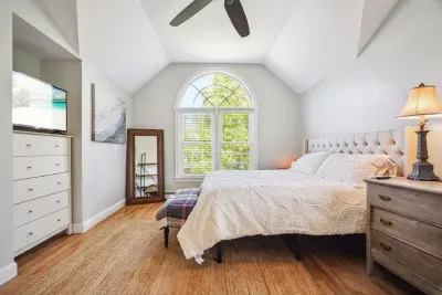The primary bedroom with a king bed, smart tv, ceiling fan, and ensuite bathroom. Clean towels and linens provided!