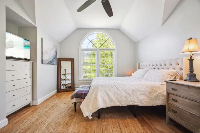 The primary bedroom with a king bed, smart tv, ceiling fan, and ensuite bathroom. Clean towels and linens provided!