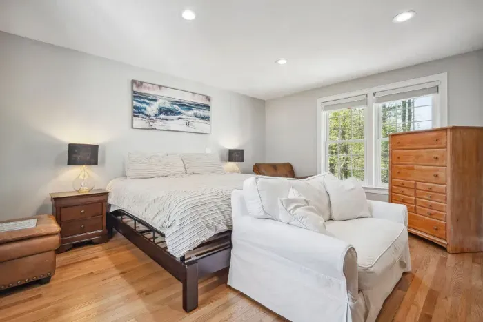 The third bedroom with a king bed, desk, and comfy love seat and chair. Clean linens provided! 