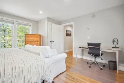 The third bedroom with a king bed, desk, and comfy love seat and chair. Clean linens provided!