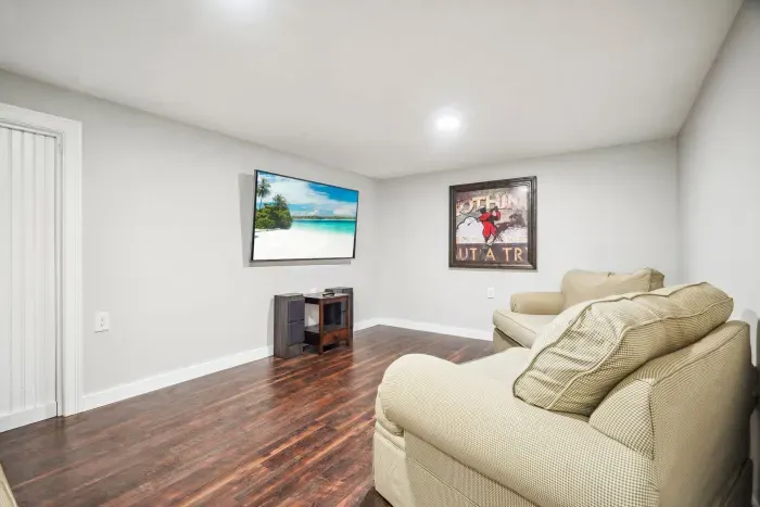 The bonus room with a smart tv located in the basement