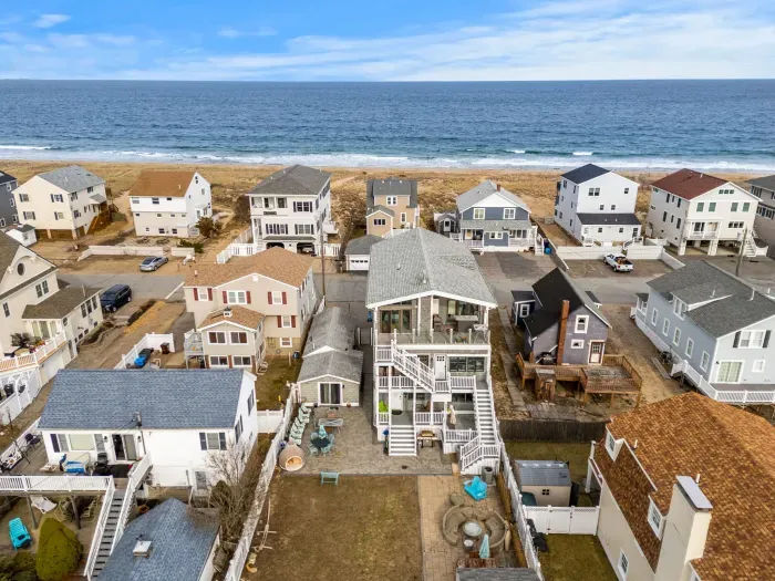Aerial view of the home! Just steps to the beach via a private beach access. The backyard space is shared with other units on the property