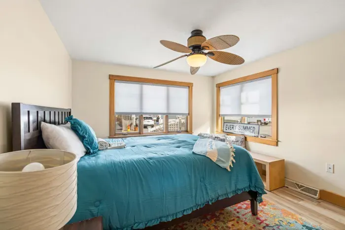 Bedroom #1 with a Queen bed, ceiling fan, and clean, provided linens. Clean towels provided for all guests!