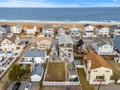 Aerial view of the home! Just steps to the beach via a private beach access. The backyard space is shared with other units on the property
