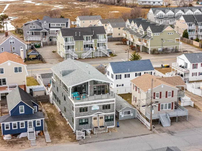Aerial view of the home! Just steps to the beach via a private beach access. 