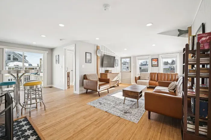 The living room with plenty of seating and a Smart TV. Plenty of natural light also! Please note the fireplace is inoperable and is not to be used.