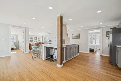 There's barstool seating for 4 and a high top table with seating for 3 located in the kitchen.
