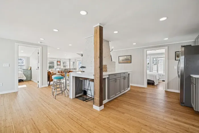 There's barstool seating for 4 and a high top table with seating for 3 located in the kitchen.