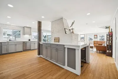 There's barstool seating for 4 and a high top table with seating for 3 located in the kitchen.