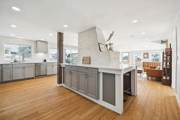 There's barstool seating for 4 and a high top table with seating for 3 located in the kitchen.