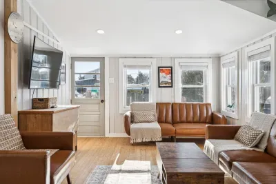 The living room with plenty of seating and a Smart TV. Plenty of natural light also!
