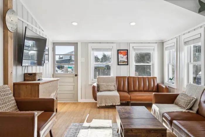 The living room with plenty of seating and a Smart TV. Plenty of natural light also!