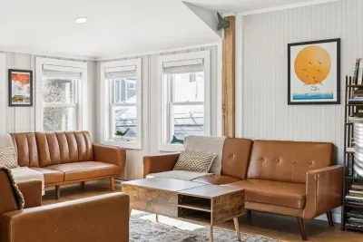 The living room with plenty of seating and a Smart TV. Plenty of natural light also!