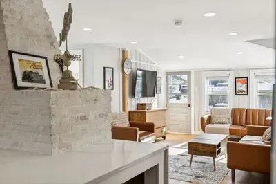 The living room with plenty of seating and a Smart TV. Plenty of natural light also! Please note the fireplace is inoperable and is not to be used.