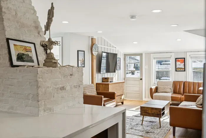 The living room with plenty of seating and a Smart TV. Plenty of natural light also! Please note the fireplace is inoperable and is not to be used.