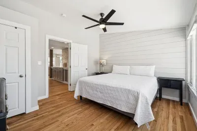 The primary bedroom with a king bed, smart TV, minisplit heating/cooling, and plenty of natural light! Clean linens provided.