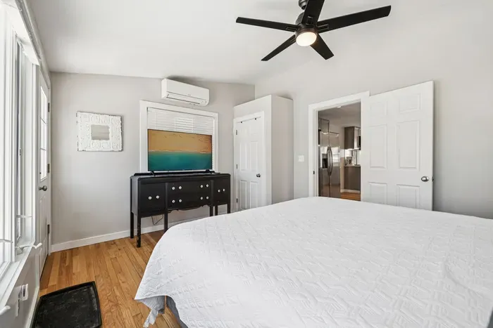 The primary bedroom with a king bed, smart TV, minisplit heating/cooling, and plenty of natural light! Clean linens provided.