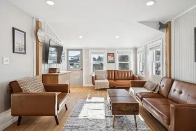 The living room with plenty of seating and a Smart TV. Plenty of natural light also!