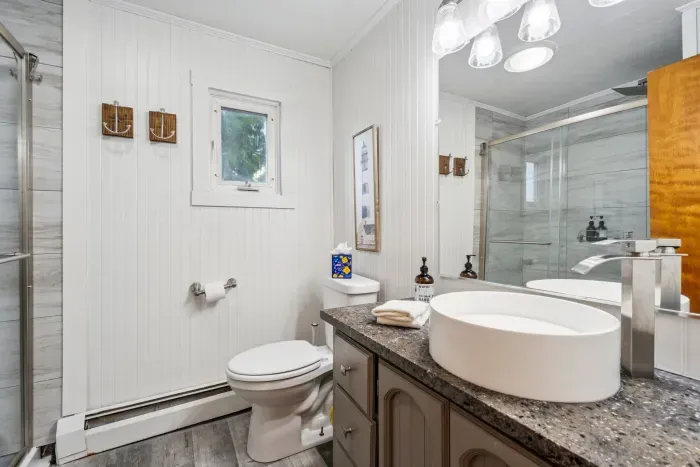 Front unit updated full bathroom with standing shower. Clean towels provided for all guests