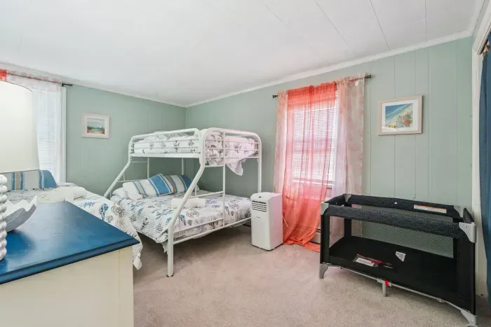 Front unit bedroom #2 featuring a twin-over-full bunk bed and twin bed. Clean linens provided