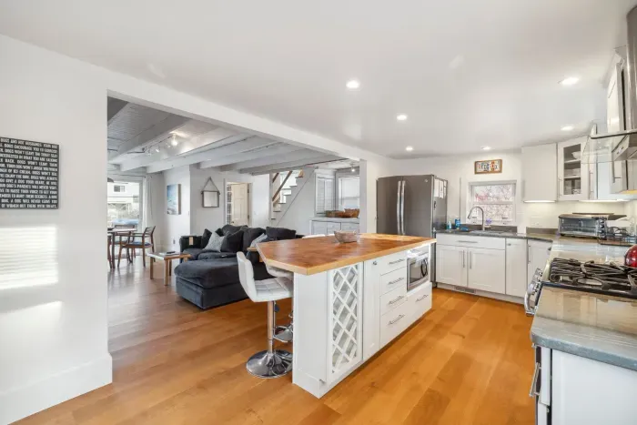 The fully equipped kitchen! This kitchen features a gas stove, seating for 4 at the island, a dishwasher and provided coffee! 