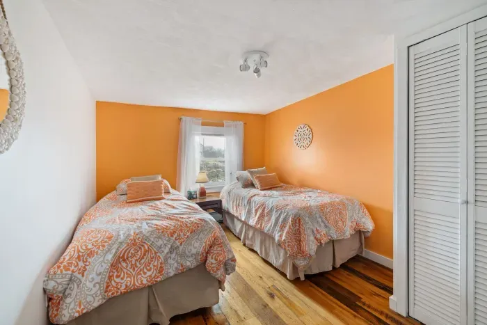 Bedroom #5 - the orange room! Two twin beds in this room with clean linens provided