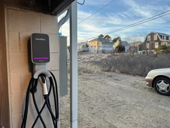 This home is equipped with a level 2 car charger. It's located under the deck right by the driveway