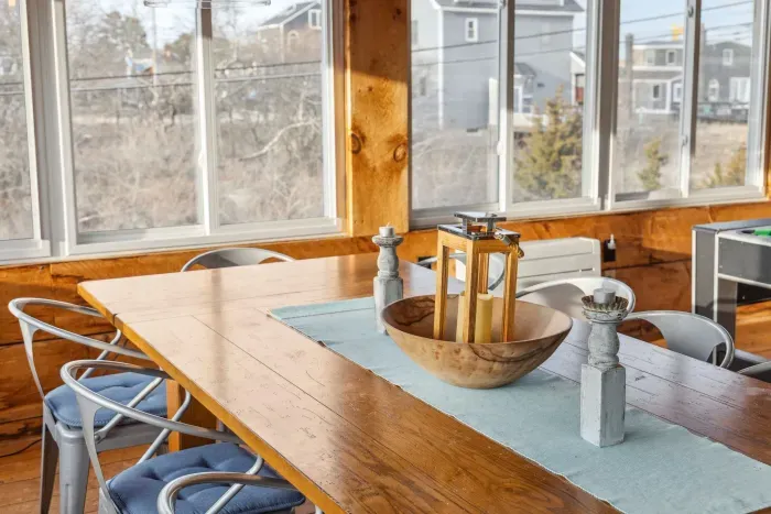 The closed in porch - This area is heated and cooled with it's own mini-split system. There is a pool/air hockey table, seating for 10 at the table, and another seating area with a sectional and chairs