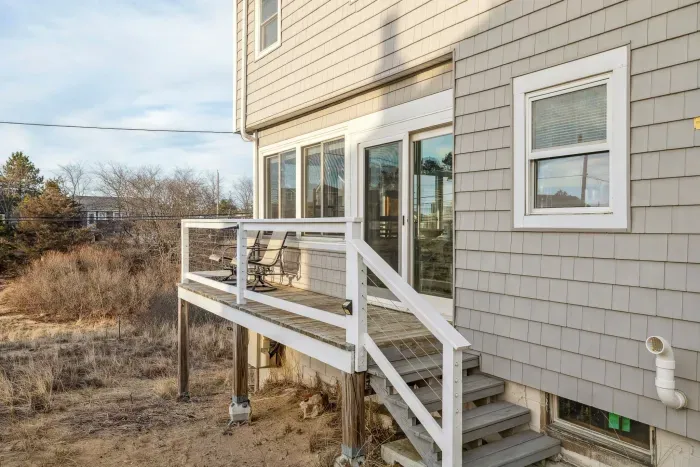 Back entrance with access to the closed in porch. There is access to the driveway around the corner