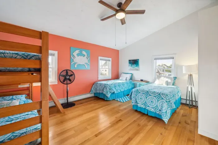 Bedroom #4 with a twin-over-twin bunk bed, and two twin single beds. This room also has a ceiling fan. Clean linens provided