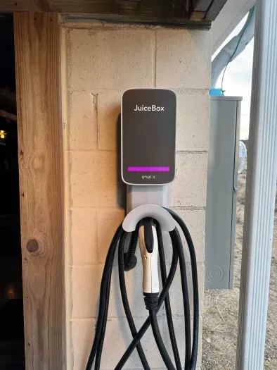 This home is equipped with a level 2 car charger. It's located under the deck right by the driveway
