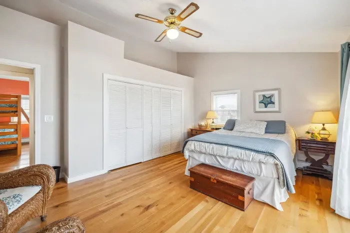The primary bedroom - this room has a queen bed, smart TV, and a slider with ocean views. Clean linens provided