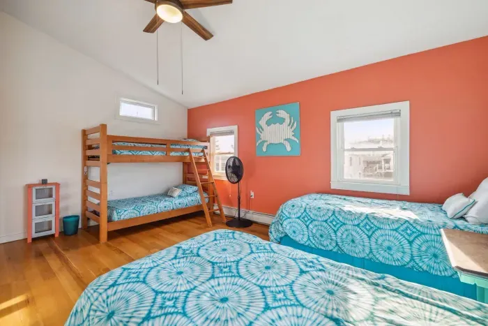 Bedroom #4 with a twin-over-twin bunk bed, and two twin single beds. This room also has a ceiling fan. Clean linens provided