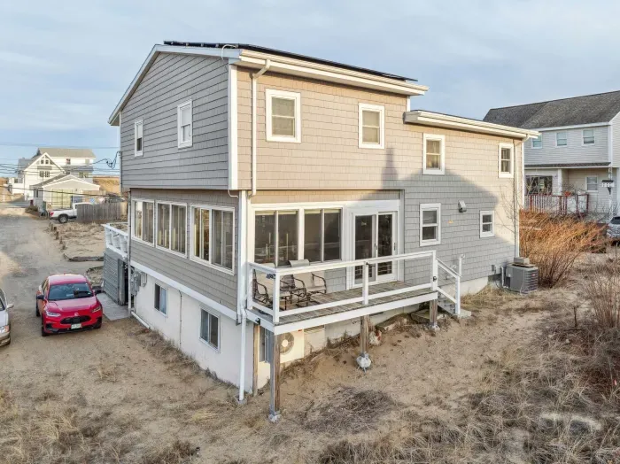 The back of the home. See the small flight of stairs leading down to access the driveway.