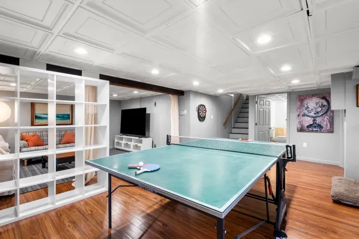 Basement ping pong table and dartboard for entertainment