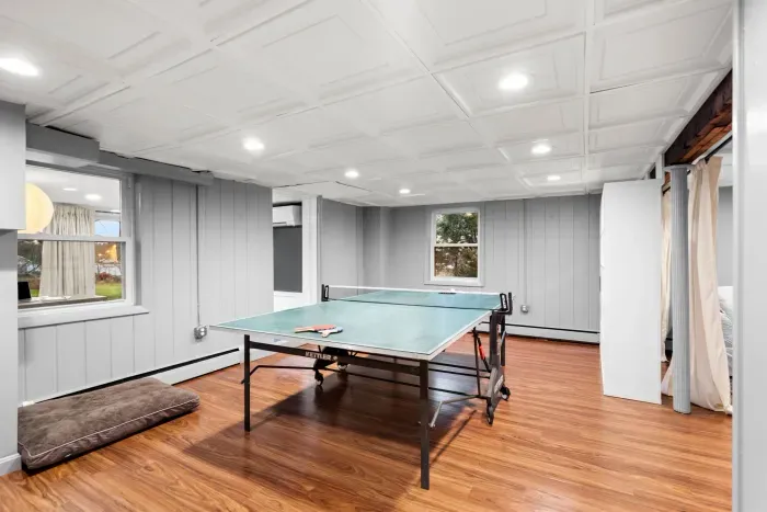 Basement ping pong table and dartboard for entertainment