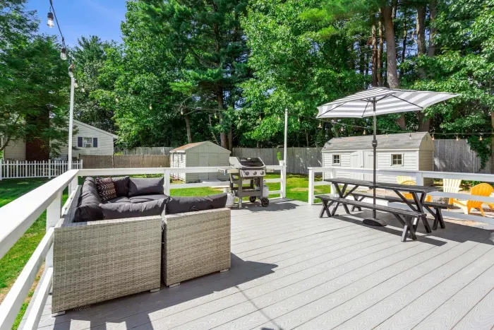 Patio setup with a grill and umbrella, perfect for outdoor dining and relaxing in the shade. ☀️🍴