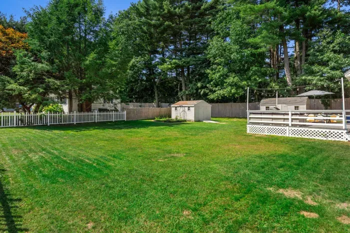 Exterior view of the back of the property showcasing its expansive yard—perfect for relaxation and outdoor fun!