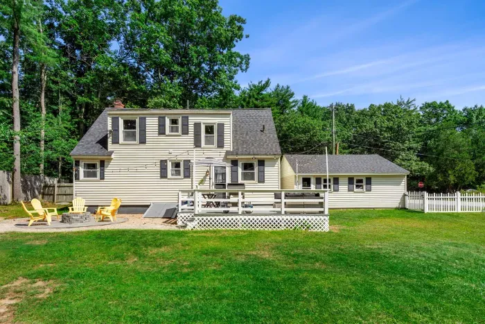 Exterior view of the back of the property showcasing its expansive yard—perfect for relaxation and outdoor fun!