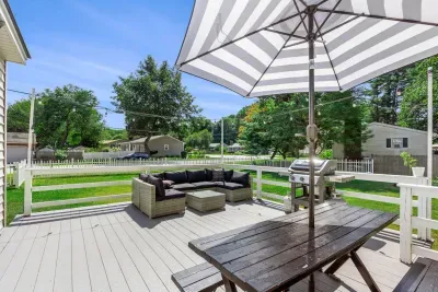 Patio setup with a grill and umbrella, perfect for outdoor dining and relaxing in the shade. ☀️🍴