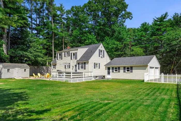 Exterior view of the back of the property showcasing its expansive yard—perfect for relaxation and outdoor fun!